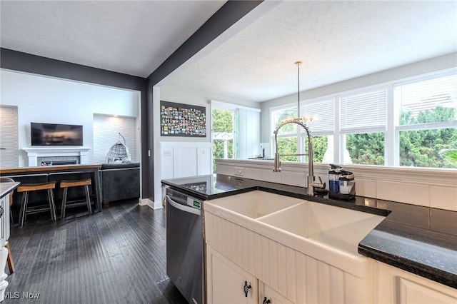 443 S Hametown Rd, Copley, OH 44321 - kitchen with stainless steel dishwasher, a sink, dark wood finished floors, open floor plan, and a fireplace
