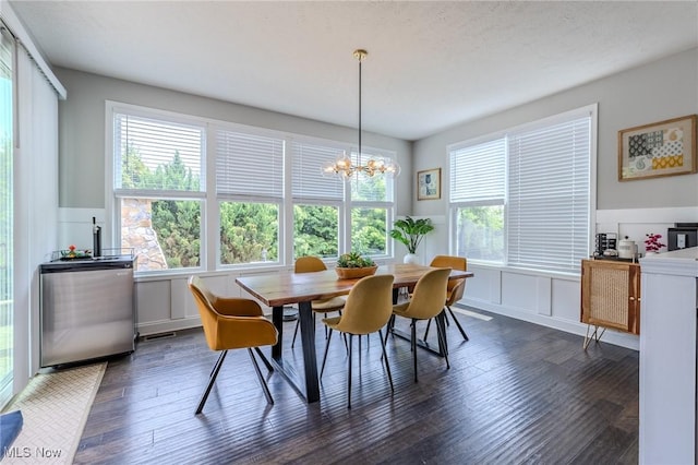 443 S Hametown Rd, Copley, OH 44321 - dining room with dark wood finished floors, healthy amount of natural light, a chandelier, a wainscoted wall, and a decorative wall