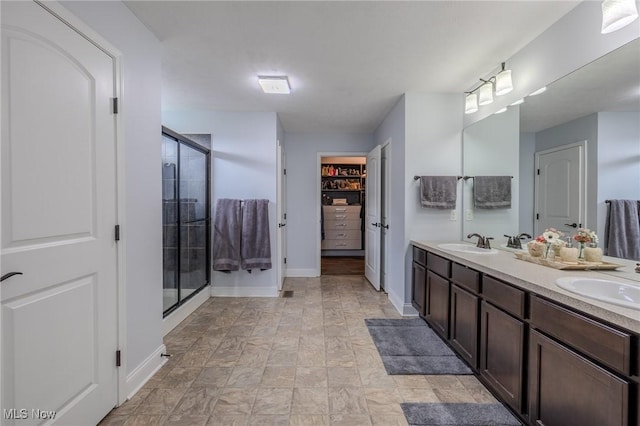 443 S Hametown Rd, Copley, OH 44321 - bathroom featuring double vanity, a shower stall, baseboards, and stone finish floors