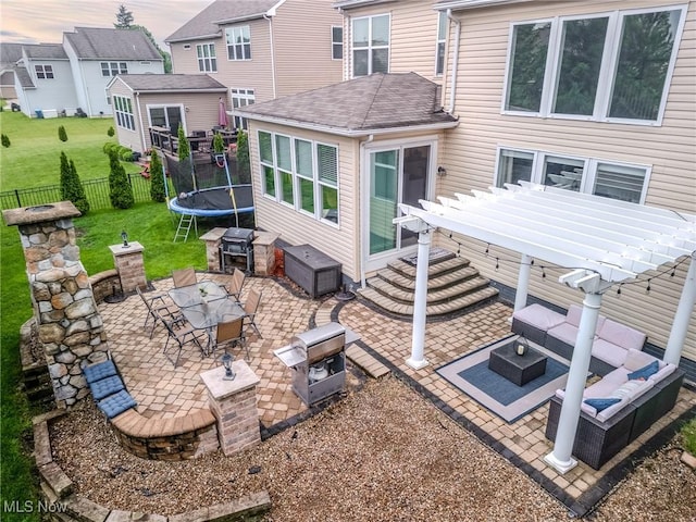 443 S Hametown Rd, Copley, OH 44321 - back of house featuring a patio area, an outdoor hangout area, a pergola, and a trampoline