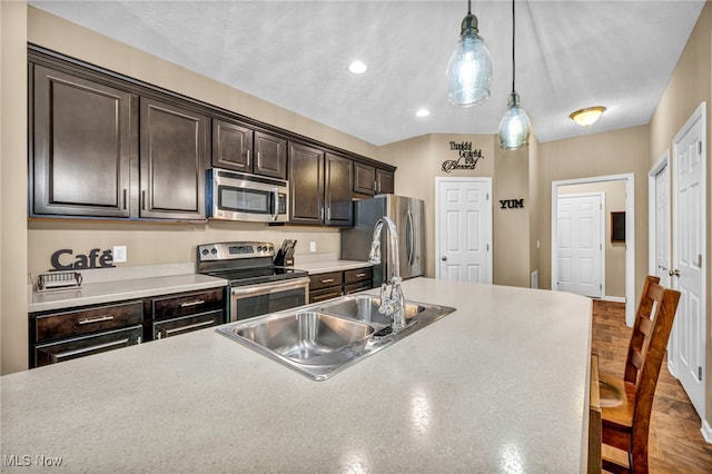 713 Westpointe Dr, Amherst, OH 44001 - kitchen featuring appliances with stainless steel finishes, dark brown cabinets, decorative light fixtures, light countertops, and recessed lighting