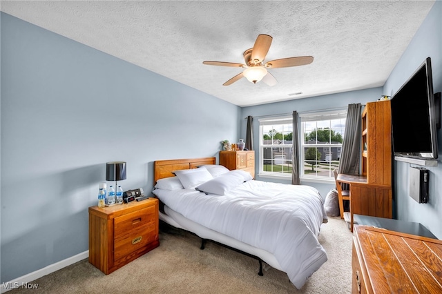 713 Westpointe Dr, Amherst, OH 44001 - bedroom featuring carpet flooring, a textured ceiling, baseboards, and ceiling fan