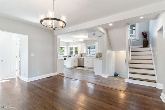 3566 Ludgate Rd, Shaker Heights, OH 44120 - unfurnished living room with a chandelier, wood finished floors, stairway, baseboards, and recessed lighting