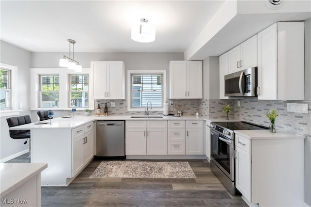 3566 Ludgate Rd, Shaker Heights, OH 44120 - kitchen featuring appliances with stainless steel finishes, a peninsula, healthy amount of natural light, and tasteful backsplash