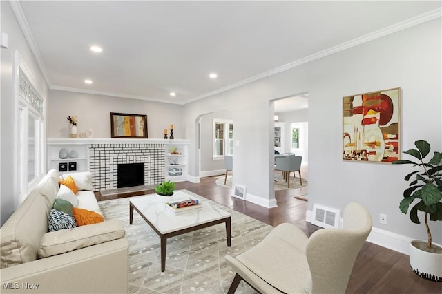 3566 Ludgate Rd, Shaker Heights, OH 44120 - living area with crown molding, recessed lighting, wood finished floors, baseboards, and a tiled fireplace