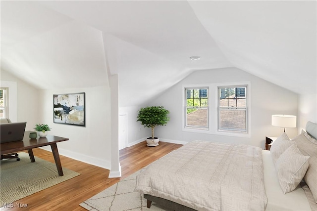 3566 Ludgate Rd, Shaker Heights, OH 44120 - bedroom featuring vaulted ceiling, multiple windows, light wood finished floors, and a desk