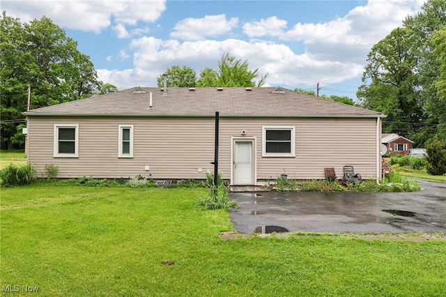 153 N Doan Ave, Painesville, OH 44077 - back of house with a lawn, a patio area, and a shingled roof