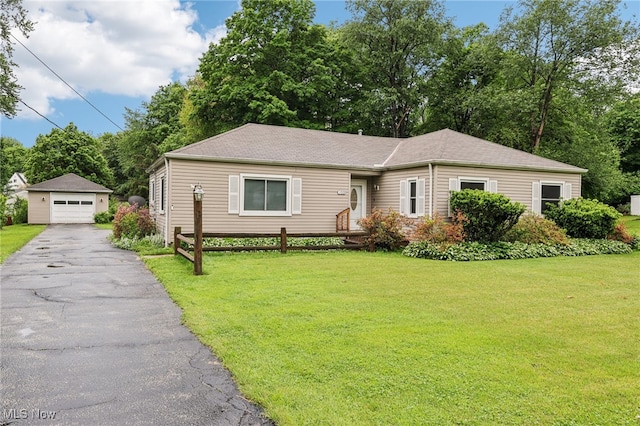 153 N Doan Ave, Painesville, OH 44077 - view of front of home featuring a garage, a front yard, and an outbuilding