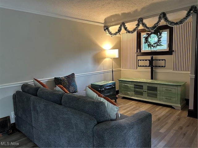 16112 Raymond St, Maple Heights, OH 44137 - living room with wood finished floors, crown molding, and a textured ceiling