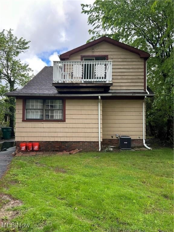 16112 Raymond St, Maple Heights, OH 44137 - back of house with a balcony, a yard, and central air condition unit