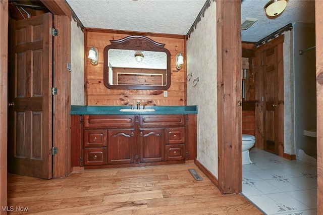 5360 Lance Rd, Medina, OH 44256 - bathroom with toilet, vanity, a textured ceiling, wood finished floors, and baseboards
