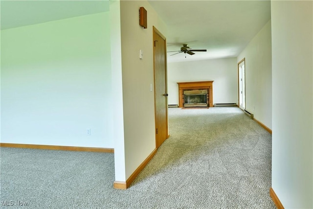 5990 Stewart Sharon Rd, Hubbard, OH 44425 - unfurnished living room featuring carpet flooring, a ceiling fan, a brick fireplace, baseboards, and a baseboard heating unit