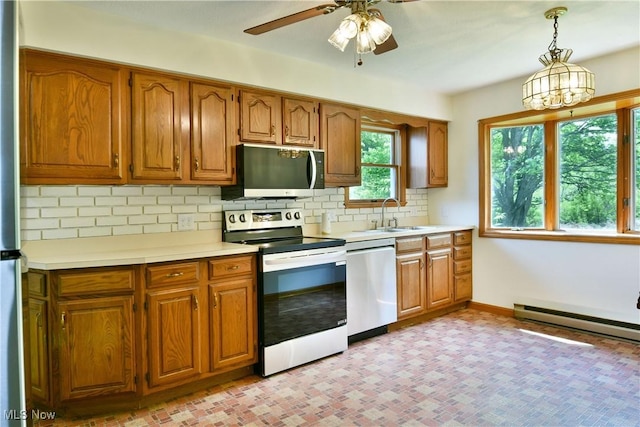 5990 Stewart Sharon Rd, Hubbard, OH 44425 - kitchen featuring appliances with stainless steel finishes, a sink, light countertops, brown cabinets, and backsplash
