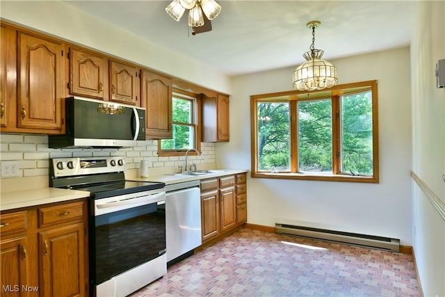 5990 Stewart Sharon Rd, Hubbard, OH 44425 - kitchen with stainless steel appliances, baseboard heating, brown cabinets, and tasteful backsplash