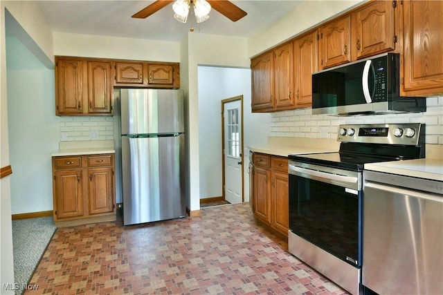 5990 Stewart Sharon Rd, Hubbard, OH 44425 - kitchen featuring appliances with stainless steel finishes, ceiling fan, light countertops, and brown cabinetry