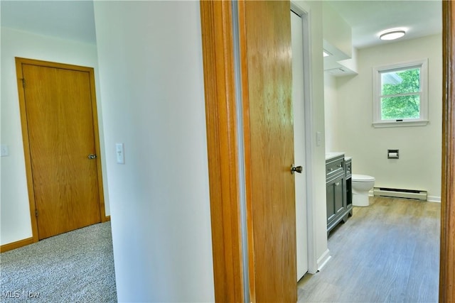 5990 Stewart Sharon Rd, Hubbard, OH 44425 - hall featuring a baseboard heating unit, light wood-style floors, and baseboards