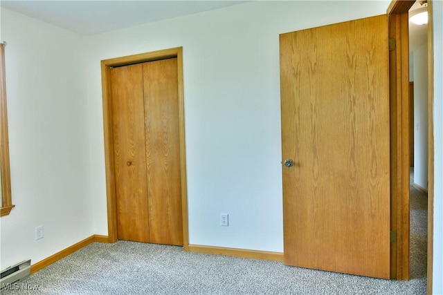 5990 Stewart Sharon Rd, Hubbard, OH 44425 - unfurnished bedroom featuring carpet, a baseboard radiator, baseboards, and a closet