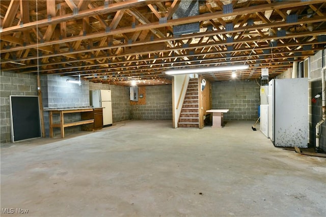 5990 Stewart Sharon Rd, Hubbard, OH 44425 - unfinished basement with freestanding refrigerator, stairway, electric panel, and concrete block wall