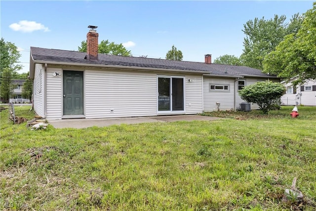 6265 Jaycox Rd, North Ridgeville, OH 44039 - back of house featuring a chimney, a lawn, a patio, and central air condition unit