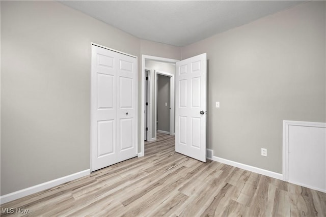 6265 Jaycox Rd, North Ridgeville, OH 44039 - unfurnished bedroom with light wood finished floors, baseboards, and a closet