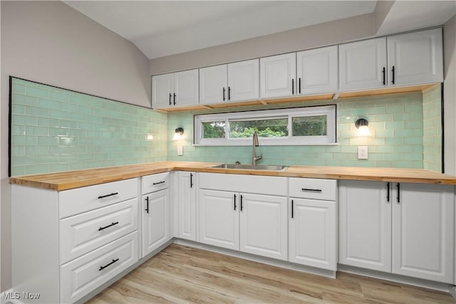 6265 Jaycox Rd, North Ridgeville, OH 44039 - kitchen with wooden counters, a sink, backsplash, and light wood-type flooring
