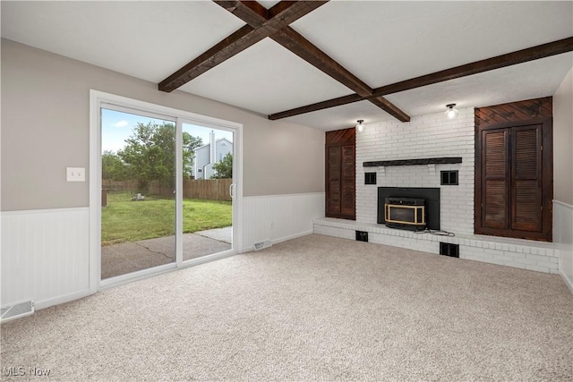 6265 Jaycox Rd, North Ridgeville, OH 44039 - unfurnished living room featuring wainscoting, beam ceiling, carpet flooring, and a fireplace