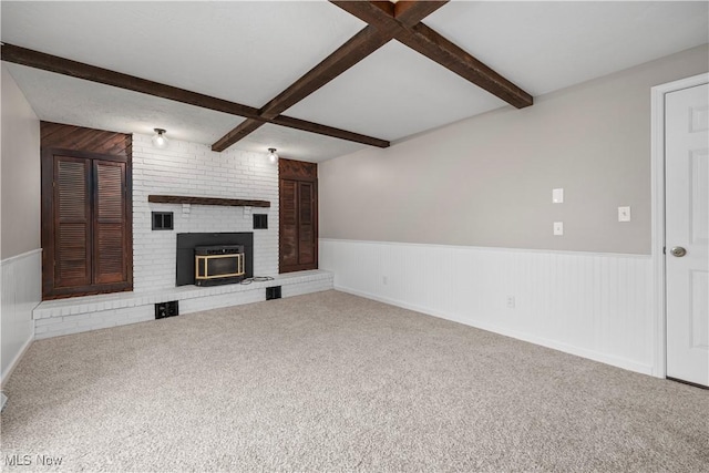 6265 Jaycox Rd, North Ridgeville, OH 44039 - unfurnished living room featuring wainscoting, beam ceiling, carpet floors, and a fireplace
