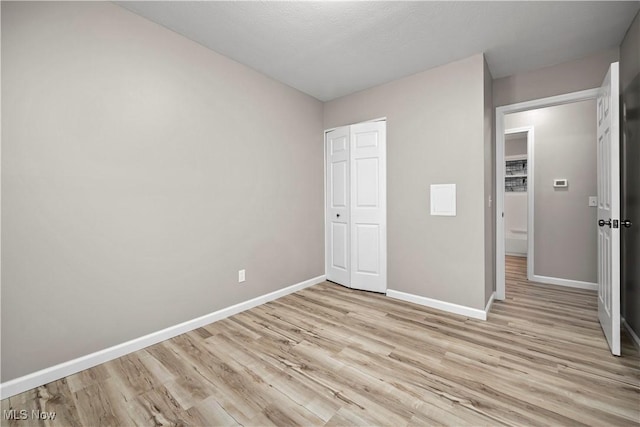 6265 Jaycox Rd, North Ridgeville, OH 44039 - unfurnished bedroom with baseboards, light wood-style floors, and a closet