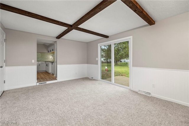 6265 Jaycox Rd, North Ridgeville, OH 44039 - carpeted spare room featuring a wainscoted wall and beamed ceiling