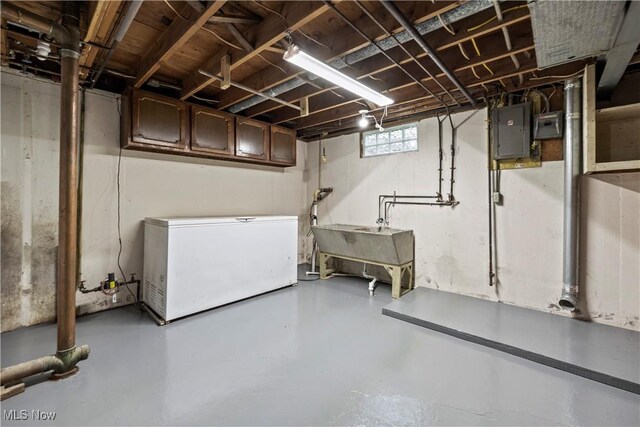 6265 Jaycox Rd, North Ridgeville, OH 44039 - basement featuring fridge, electric panel, and a sink