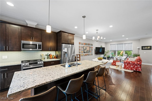 1343 W Clifton Blvd, Lakewood, OH 44107 - kitchen featuring appliances with stainless steel finishes, a sink, a breakfast bar area, a chandelier, and recessed lighting