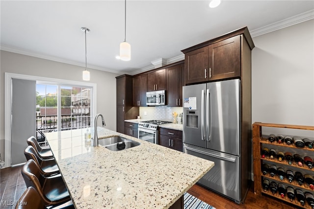1343 W Clifton Blvd, Lakewood, OH 44107 - kitchen with stainless steel appliances, a sink, crown molding, dark brown cabinets, and dark wood-type flooring