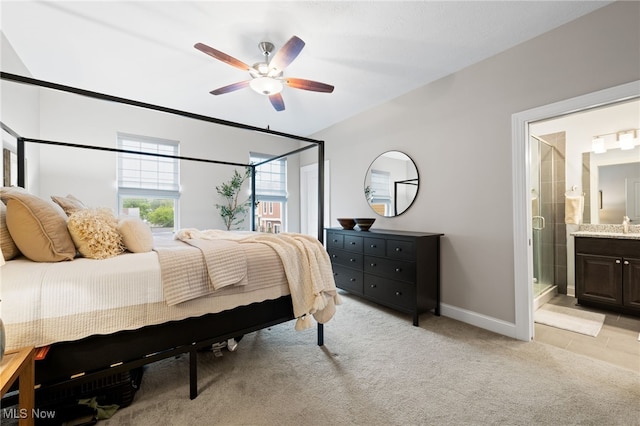 1343 W Clifton Blvd, Lakewood, OH 44107 - bedroom featuring connected bathroom, light carpet, baseboards, and a ceiling fan