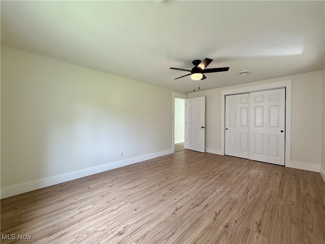 6250 W Liberty St, Hubbard, OH 44425 - unfurnished bedroom featuring wood finished floors, baseboards, a closet, and ceiling fan