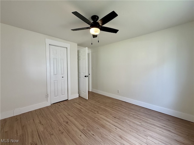 6250 W Liberty St, Hubbard, OH 44425 - unfurnished bedroom featuring light wood finished floors, baseboards, a ceiling fan, and a closet