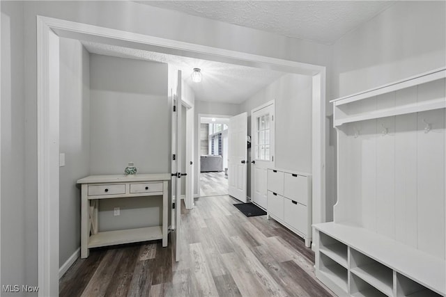 301 Tower Ln, Amherst, OH 44001 - mudroom featuring a textured ceiling, wood finished floors, and baseboards