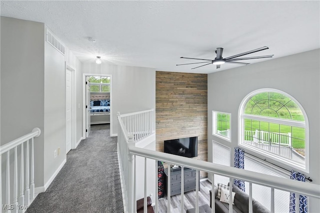 301 Tower Ln, Amherst, OH 44001 - corridor featuring an upstairs landing, carpet, and baseboards