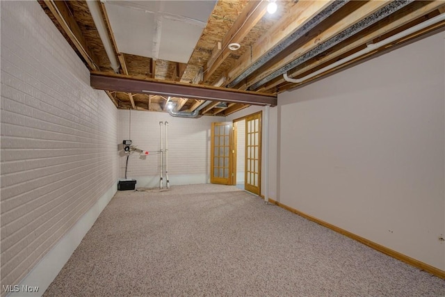 301 Tower Ln, Amherst, OH 44001 - unfinished below grade area with brick wall and carpet flooring