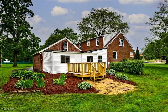 2546 Atlantic, Warren, OH 44483 - back of house with a wooden deck, a lawn, and brick siding