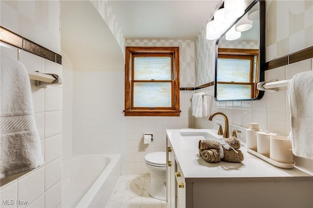 2546 Atlantic, Warren, OH 44483 - full bath with tile walls, healthy amount of natural light, toilet, vanity, and marble look tile flooring