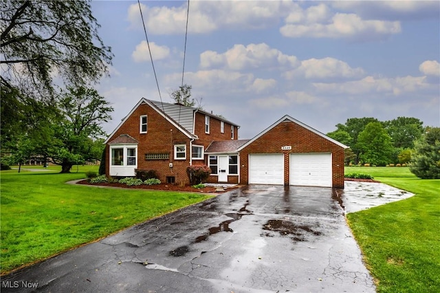 2546 Atlantic, Warren, OH 44483 - view of front of house with brick siding, driveway, a garage, and a front yard