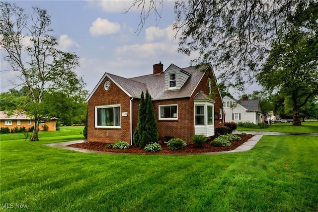 2546 Atlantic, Warren, OH 44483 - view of property exterior featuring brick siding, a yard, a chimney, and a shingled roof