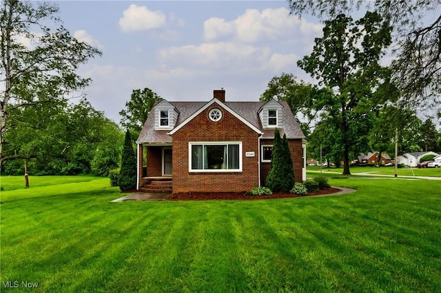 2546 Atlantic, Warren, OH 44483 - cape cod-style house with a chimney, brick siding, and a front yard