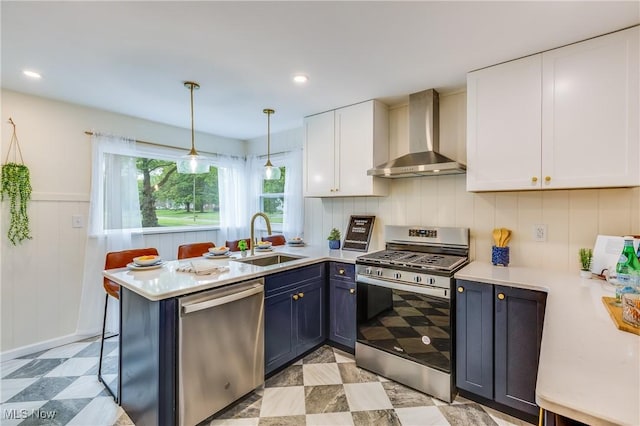 2546 Atlantic, Warren, OH 44483 - kitchen with stainless steel appliances, wall chimney range hood, a sink, white cabinets, and recessed lighting