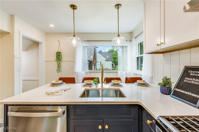 2546 Atlantic, Warren, OH 44483 - kitchen with stainless steel dishwasher, a sink, light countertops, pendant lighting, and a decorative wall