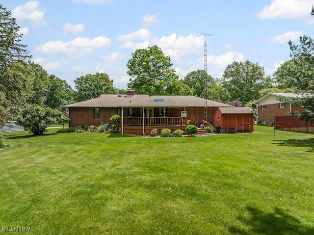 1033 Briarcliff Ave, Alliance, OH 44601 - rear view of property featuring a deck, brick siding, a yard, and a chimney