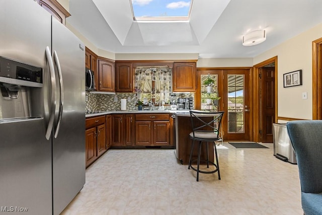 1033 Briarcliff Ave, Alliance, OH 44601 - kitchen with stainless steel appliances, tasteful backsplash, a skylight, a sink, and light floors