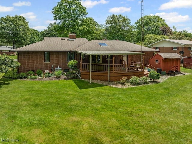 1033 Briarcliff Ave, Alliance, OH 44601 - back of house featuring a chimney, a yard, brick siding, a wooden deck, and a shingled roof