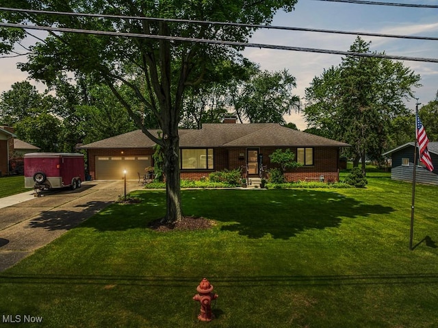 1033 Briarcliff Ave, Alliance, OH 44601 - view of front of home featuring driveway, an attached garage, a front lawn, and brick siding