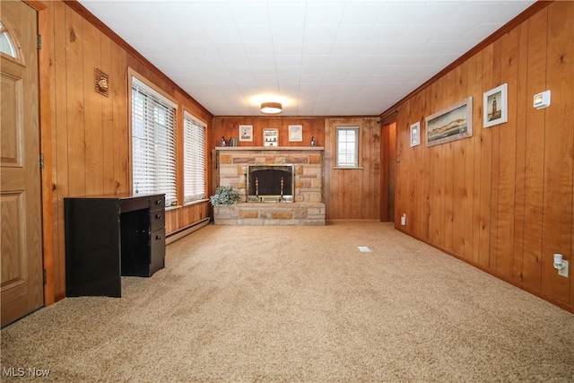58429 Lashley Rd, Senecaville, OH 43780 - unfurnished living room with a baseboard radiator, a stone fireplace, wood walls, and carpet flooring